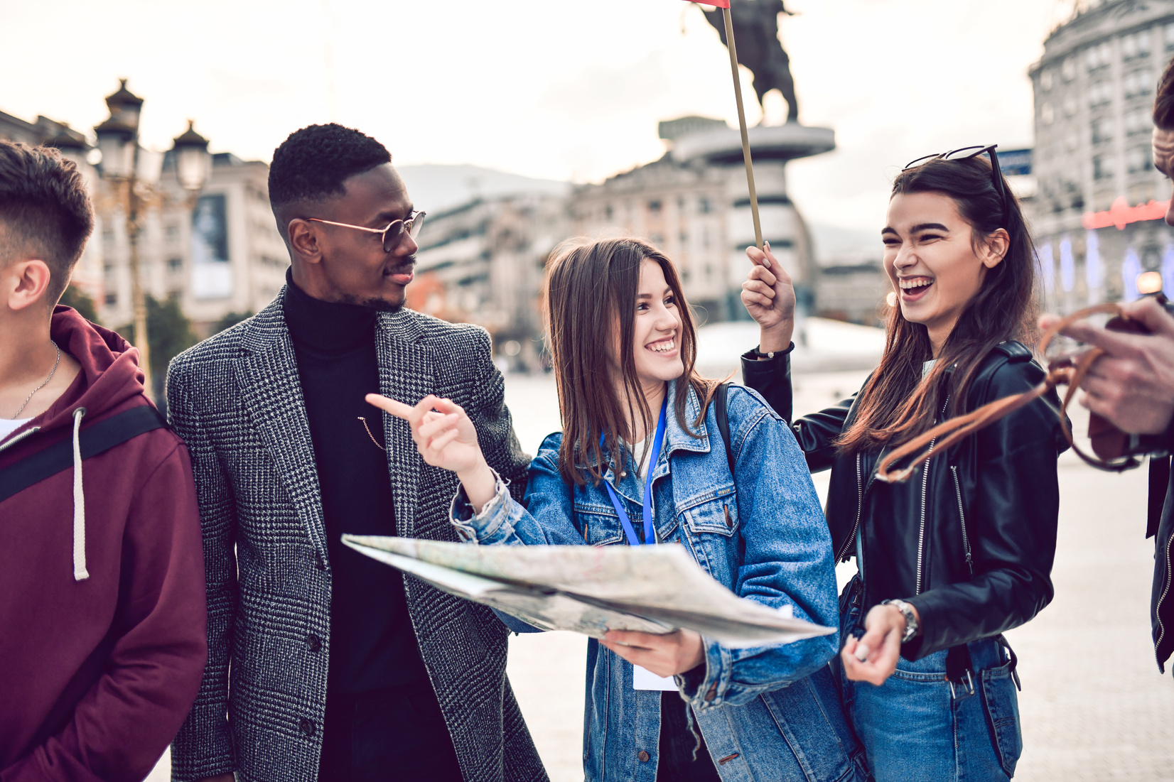 Tourists Enjoying Their Travels In City With Female Tour Guide